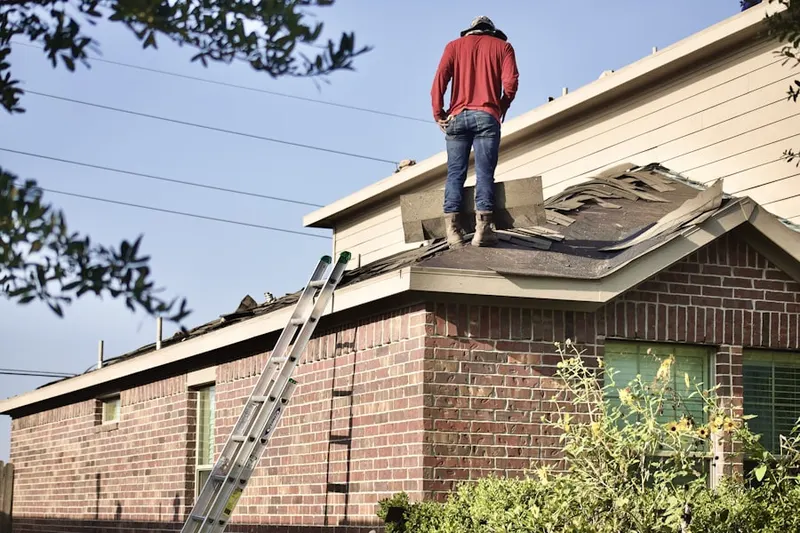 Professional roofer working on a residential roof in Walkers Choice